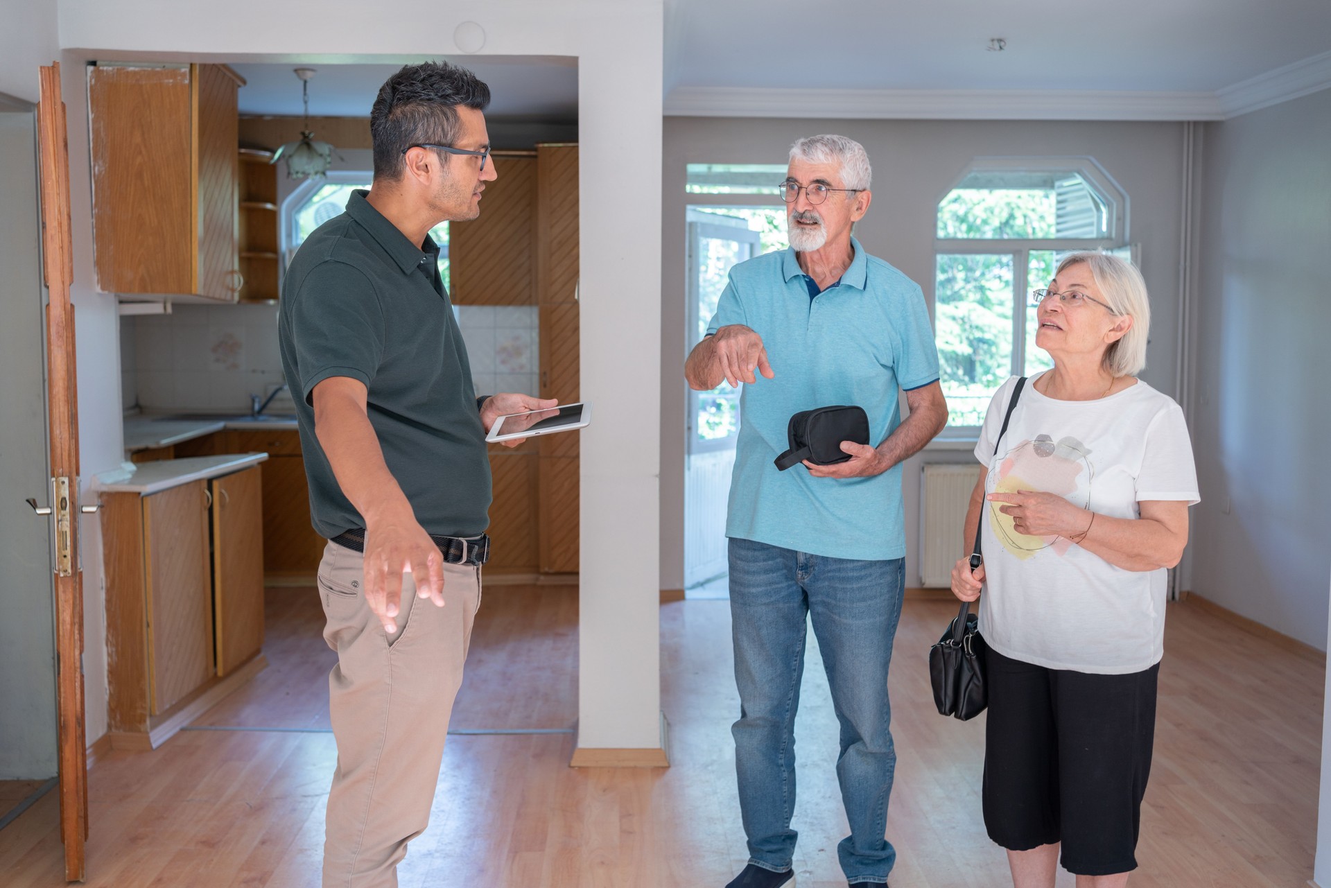 Real Estate Agent Showing A House To Senior Couple